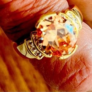 Large amber colored large center stone accented w/czs in gold colored metal